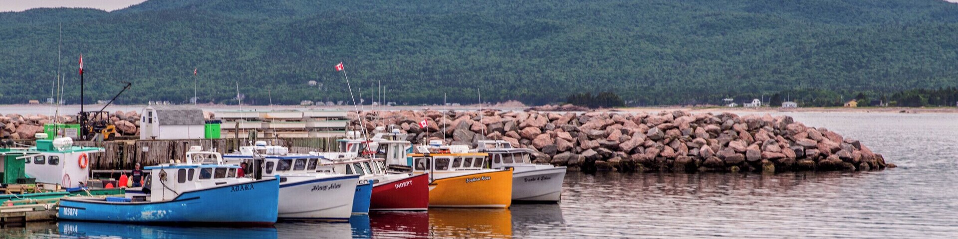 Nova Scotia is full of tiny, picturesque fishing villages, including this one full of colorful boats near Ingonish on Cape Breton Island. #novascotia #canada #capebreton