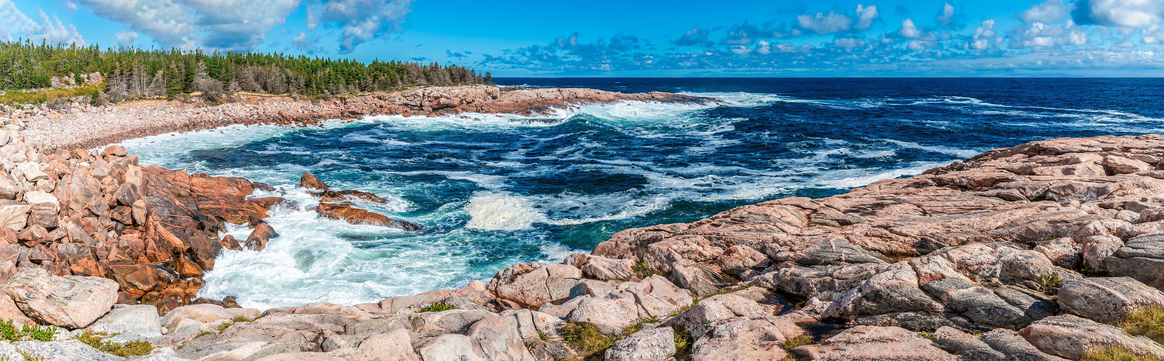 A panorama view of waves breaking in a rocky bay at Green cove, Ingonish on the Cabot Trail, Nova Scotia, Canada in the fall