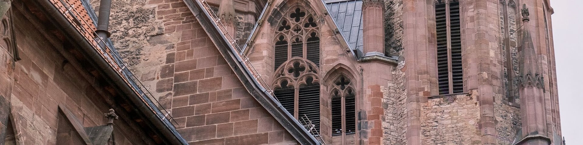 A church with a clock tower and a weather vane.