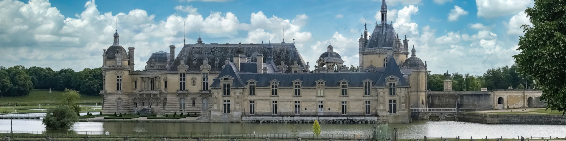 Chantilly castle, in France, beautiful palace with a lake