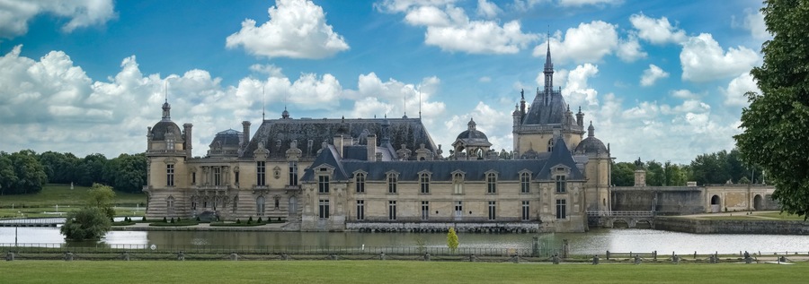 Chantilly castle, in France, beautiful palace with a lake