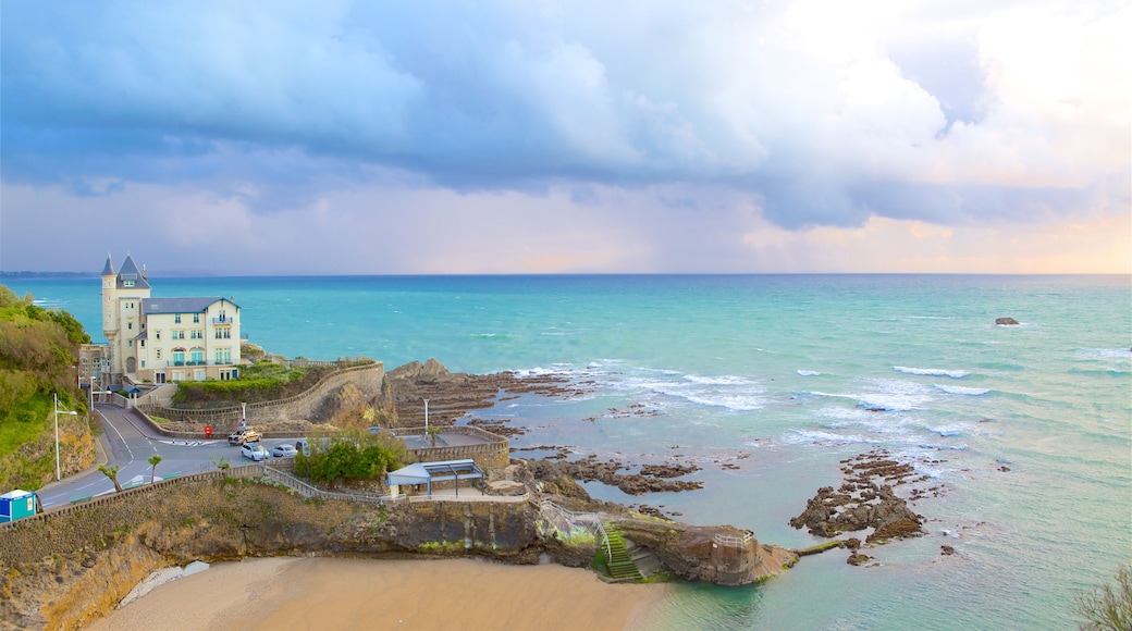 Biarritz featuring rocky coastline, a beach and general coastal views
