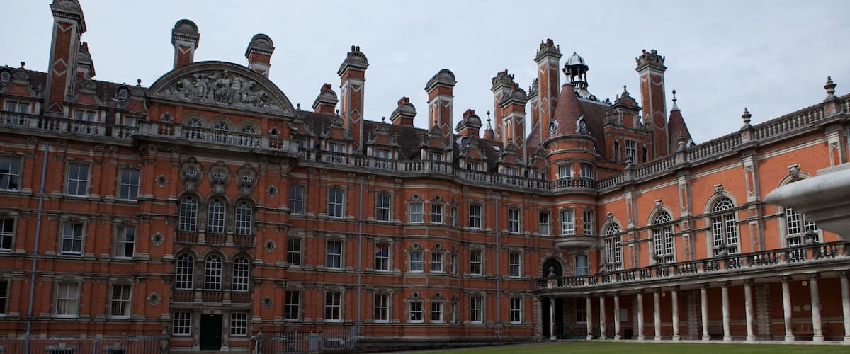 A large, ornate building with a red brick facade, multiple windows, and a central entrance.