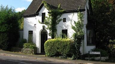 A white building with a black roof and a sign reading "Runley Ridge."