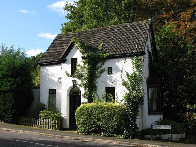 A white building with a black roof and a sign reading "Runley Ridge."