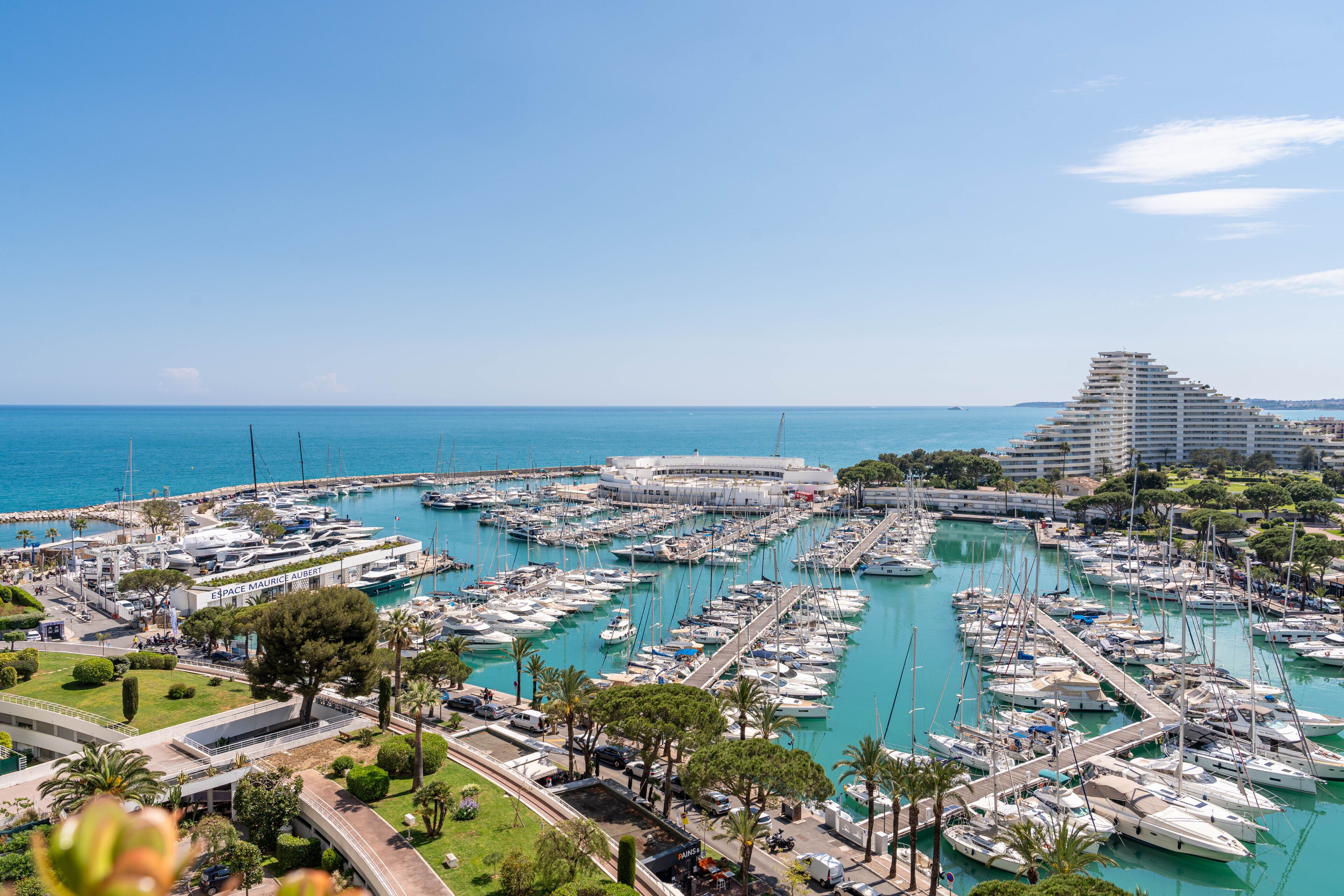Aerial view of Marina Baie des Anges in Villeneuve-Loubet – luxury yachts, turquoise water, iconic pyramid buildings and Mediterranean Sea on the French Riviera