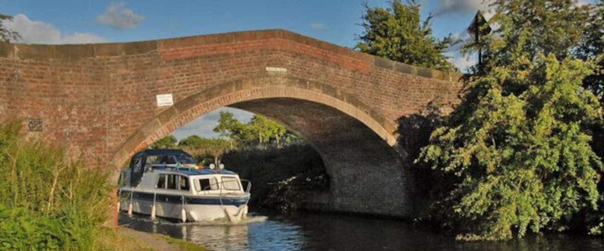 Bridge at Spud Wood Cruiser passing under bridge at Spud Wood on Bridgewater canal