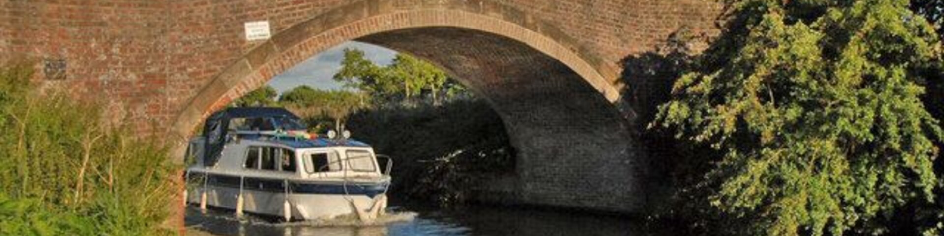 Bridge at Spud Wood Cruiser passing under bridge at Spud Wood on Bridgewater canal