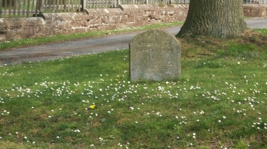 Not a gravestone! Standing just outside the churchyard the stone commemorates the coronation of George VI in 1937.