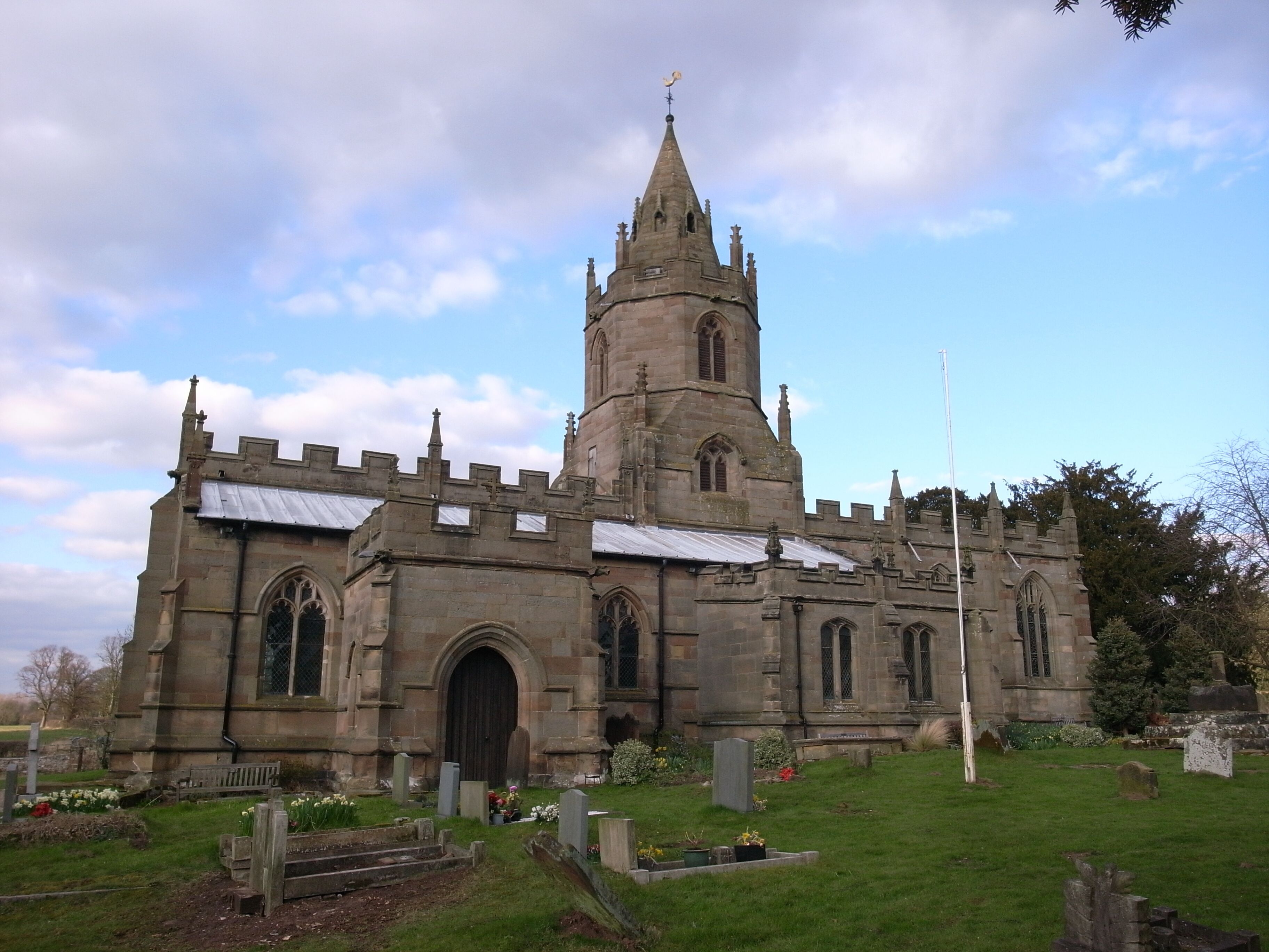 A historic church with a tall spire and arched windows.