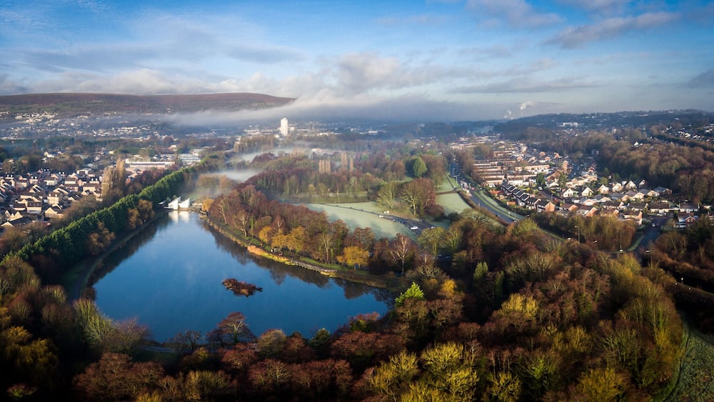 Aerial view of early morning fog and mist raising over Cwmbran, South Wales, UK