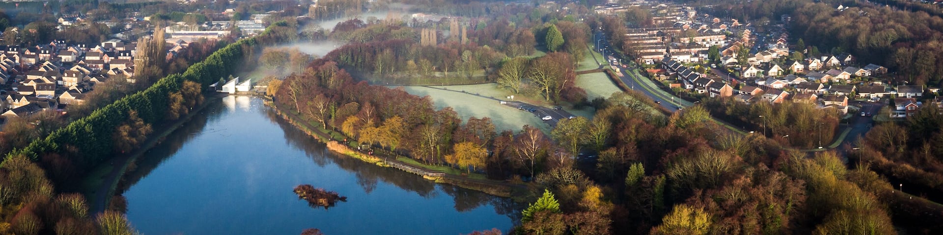 Aerial view of early morning fog and mist raising over Cwmbran, South Wales, UK