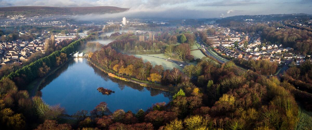 Aerial view of early morning fog and mist raising over Cwmbran, South Wales, UK