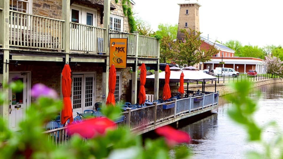 A riverside restaurant with outdoor seating and a sign reading "Mex Co."