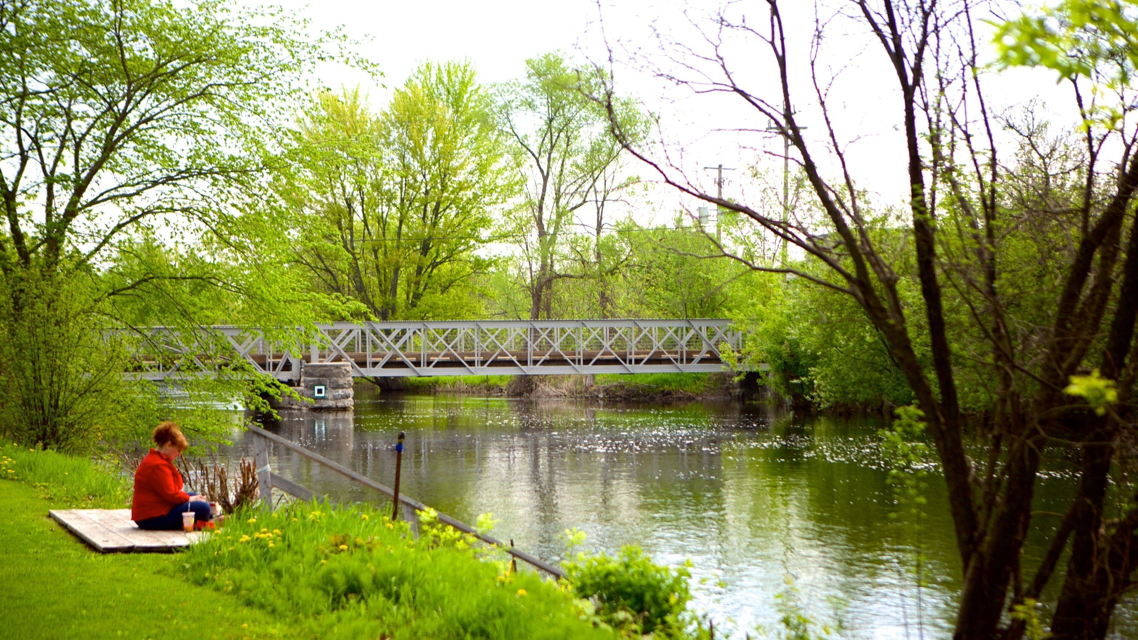 Perth featuring a bridge and a river or creek as well as an individual femail