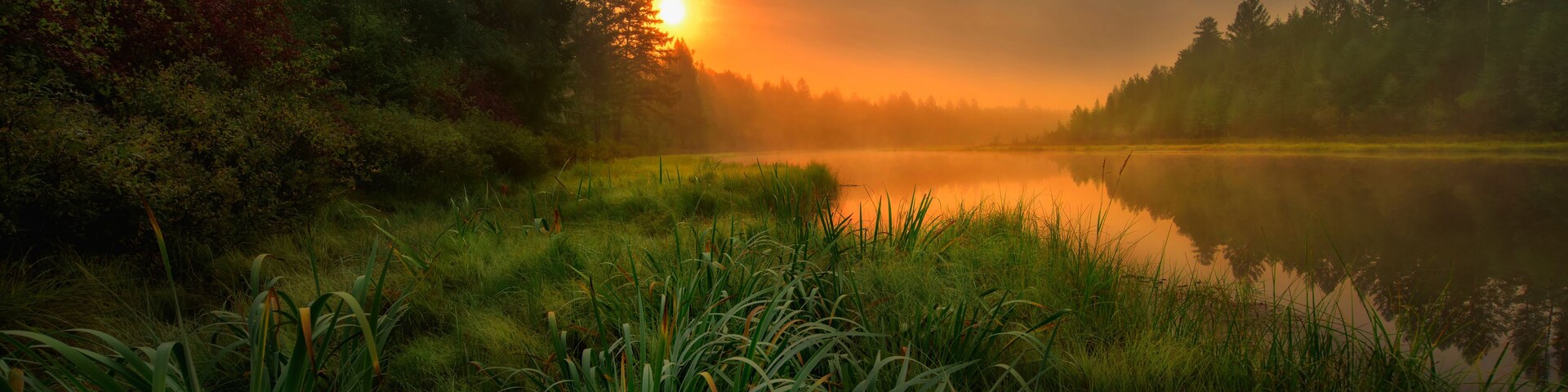 Green Canoe and Chairs on a Dock Next to a Lake at Sunset - Haliburton Highlands, Ontario, Canada