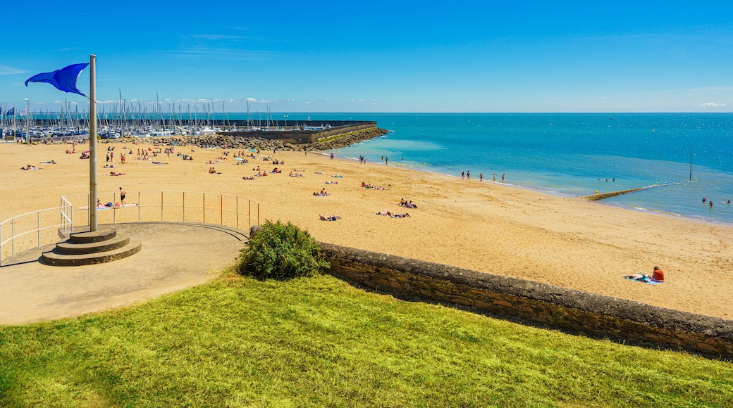Tourists enjoy a sunbath on Plage de la Noëveillard by the Atlantic Ocean in Pornic, France