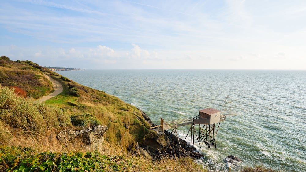 Large fishing net and a beautiful road in grassy dunes. Ocean landscape in Pornic, France.; Shutterstock ID 419394256; purchase_order: SP-1332 HA Batch 2 August 2018; Order: ; client: HomeAway; other: