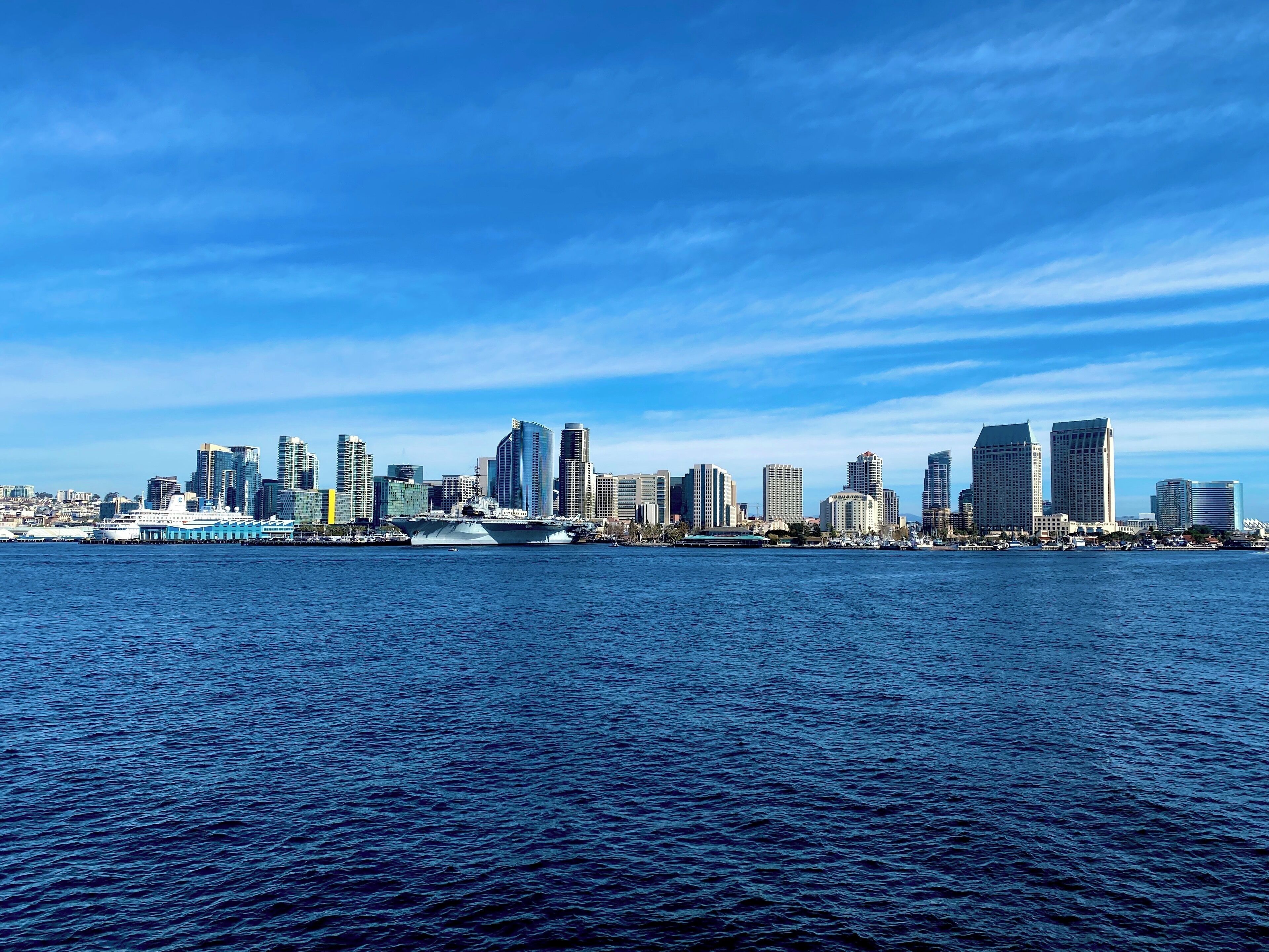 A city skyline with a large body of water in the foreground.