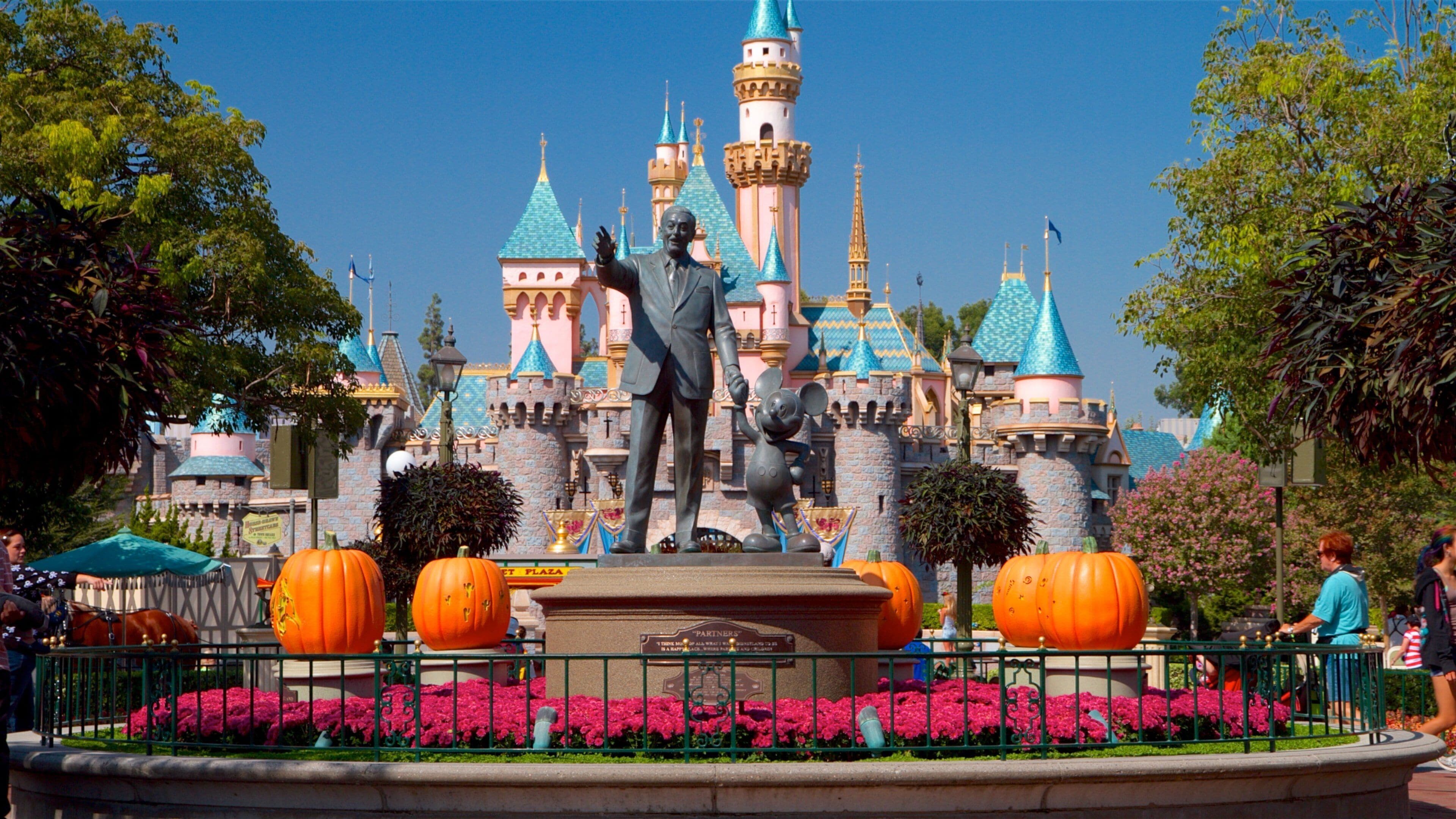 Disneyland® Park which includes rides, flowers and a statue or sculpture