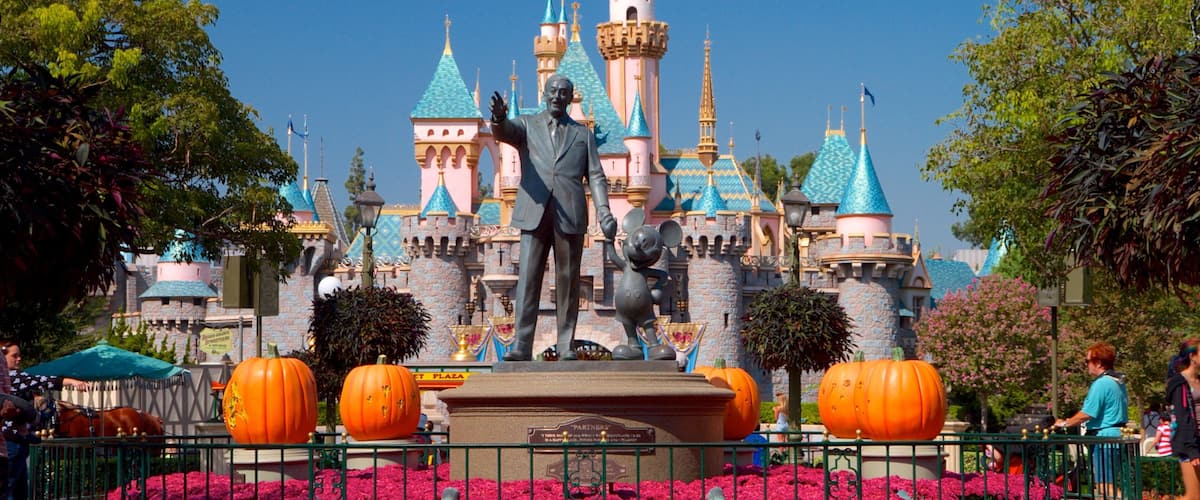 Disneyland® Park which includes rides, flowers and a statue or sculpture