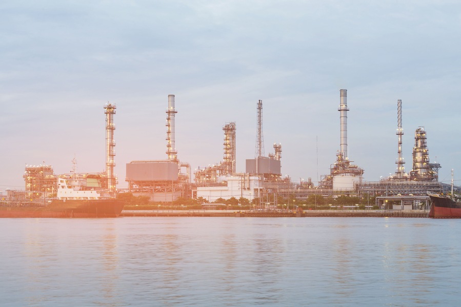 Oil refinery river front, industrial petroleum background