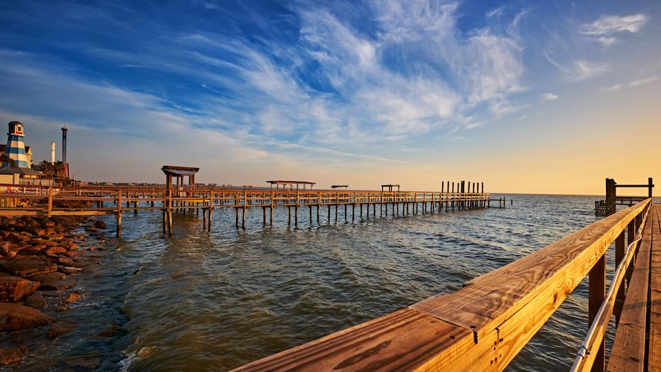 Line of wooden docks into Galveston Bay