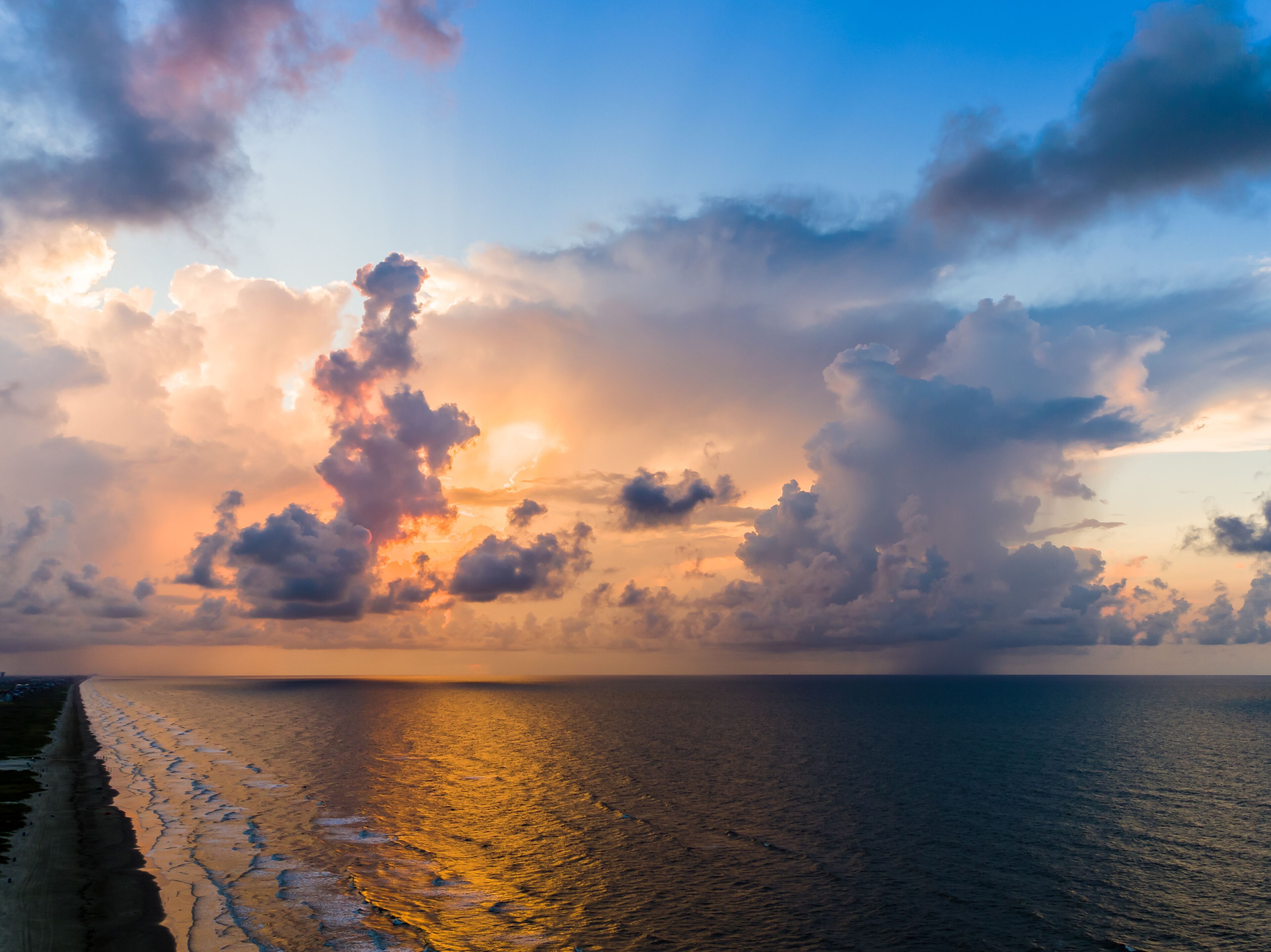 An aerial stormy beach sunrise with beautiful colors.