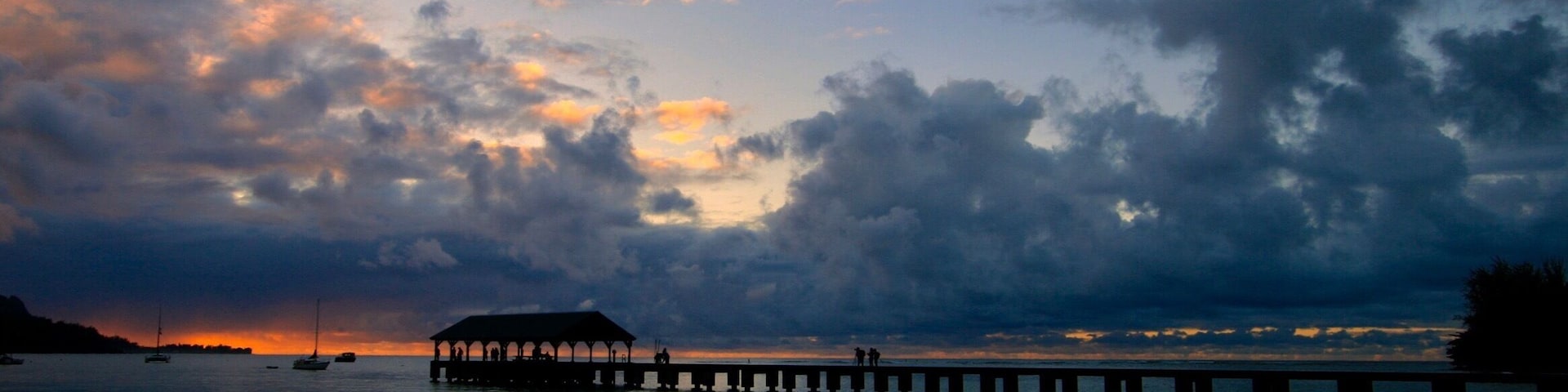 I read that the pier at Hanalei Bay was an ideal spot to take a sunset picture. On the last afternoon on Kauai, my wife and I finished some shaved ice in town and headed to the pier to catch a photo at the end of the sunset. A photographer, and bride and groom are the shadowed persons on the pier.
#BeachTips
#BVSBlue Photo Contest
