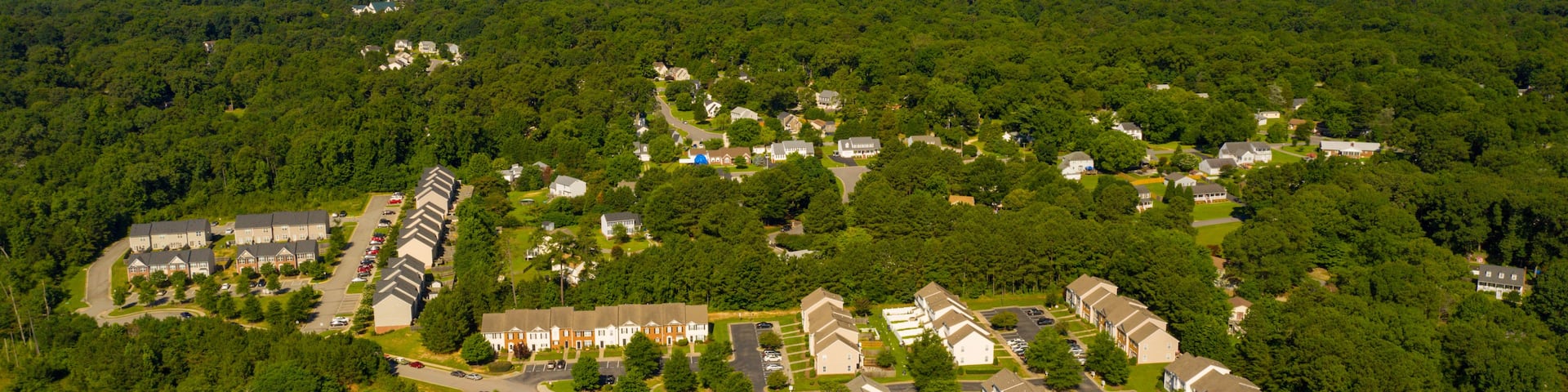 An aerial view of a residential area with houses, roads, and a water tower.