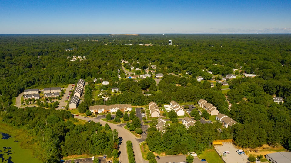 An aerial view of a residential area with houses, roads, and a water tower.
