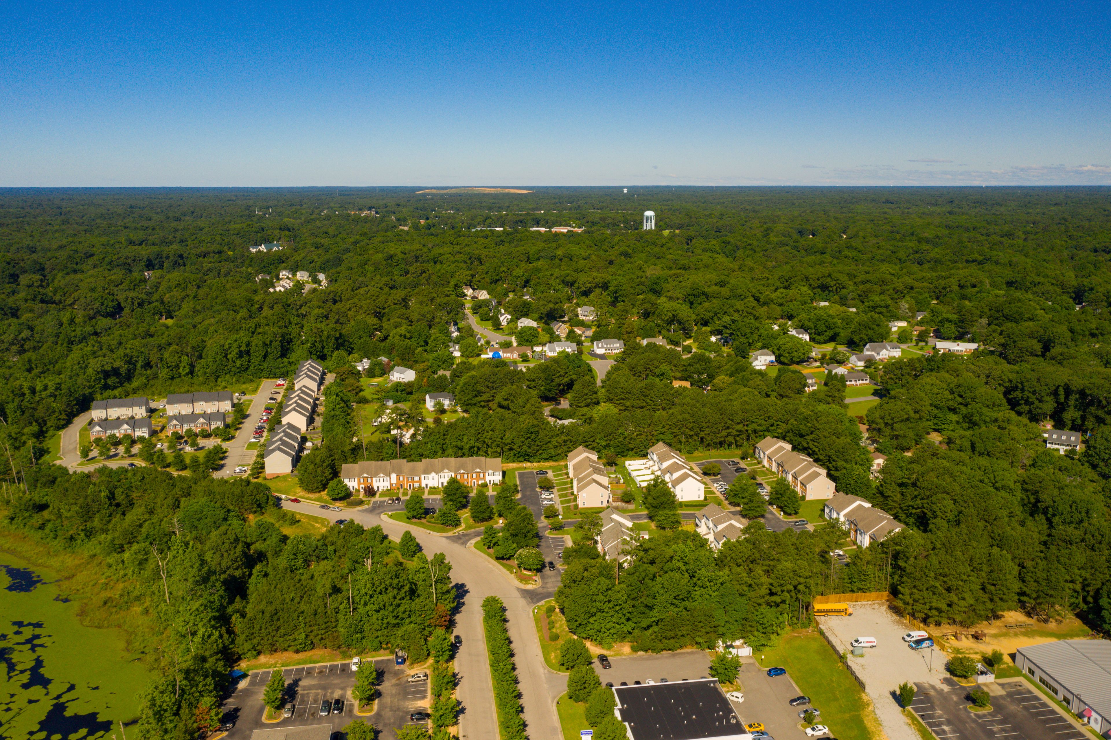 An aerial view of a residential area with houses, roads, and a water tower.