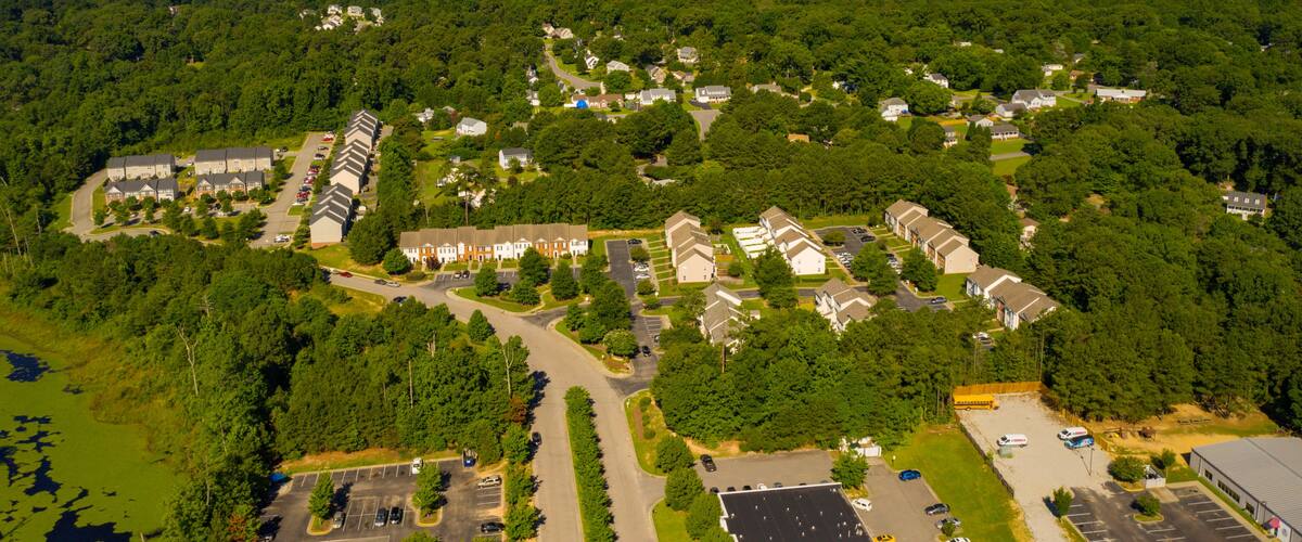 An aerial view of a residential area with houses, roads, and a water tower.