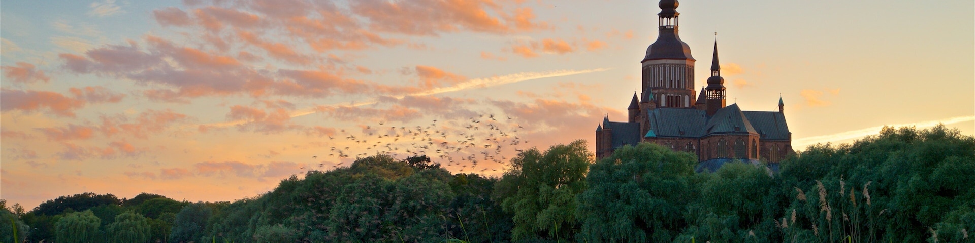 Stralsund featuring heritage architecture and a sunset