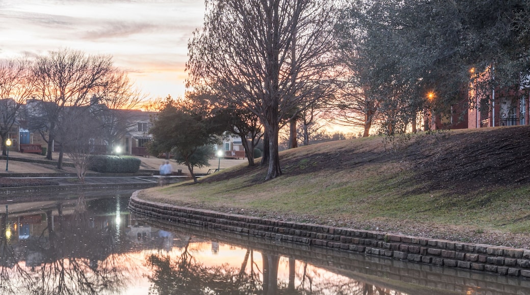 Mirror reflection of typical riverside apartment building complex at sunset in Irving, Texas, USA, wintertime. Panorama style
