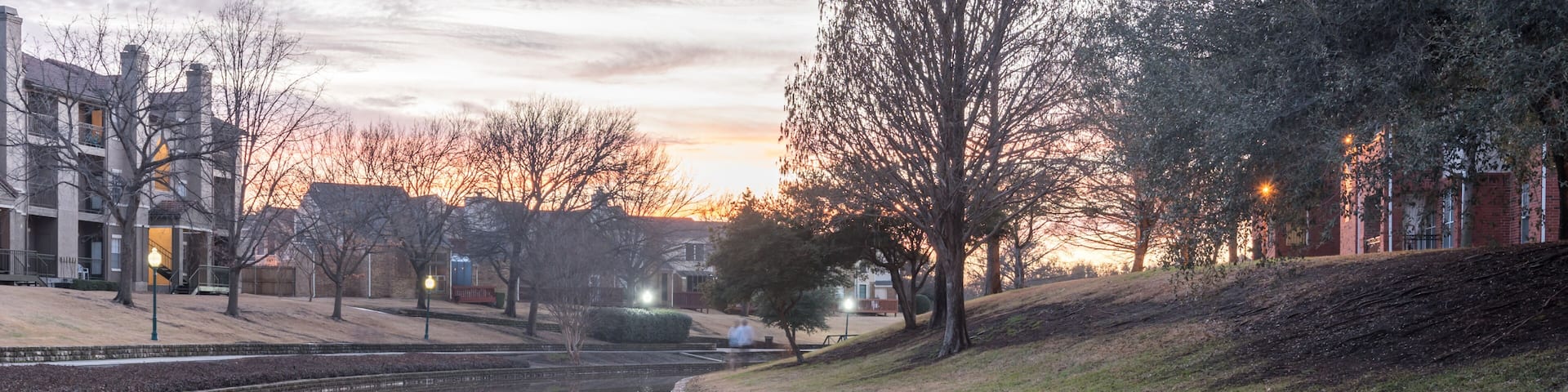 Mirror reflection of typical riverside apartment building complex at sunset in Irving, Texas, USA, wintertime. Panorama style
