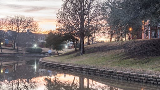 Mirror reflection of typical riverside apartment building complex at sunset in Irving, Texas, USA, wintertime. Panorama style