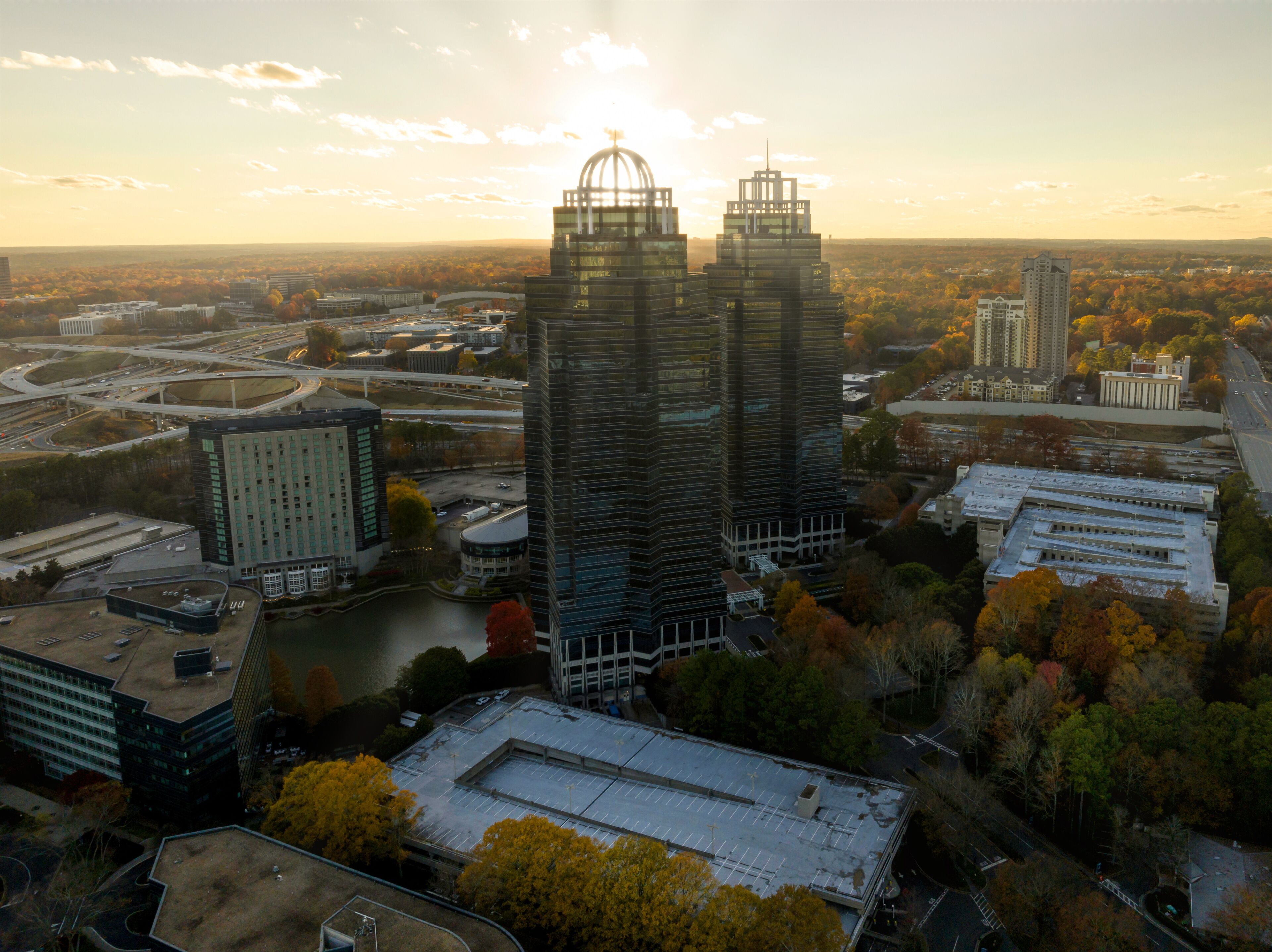 Aerial view of commercial buildings in Atlanta Metro Area with sun rays during sunset