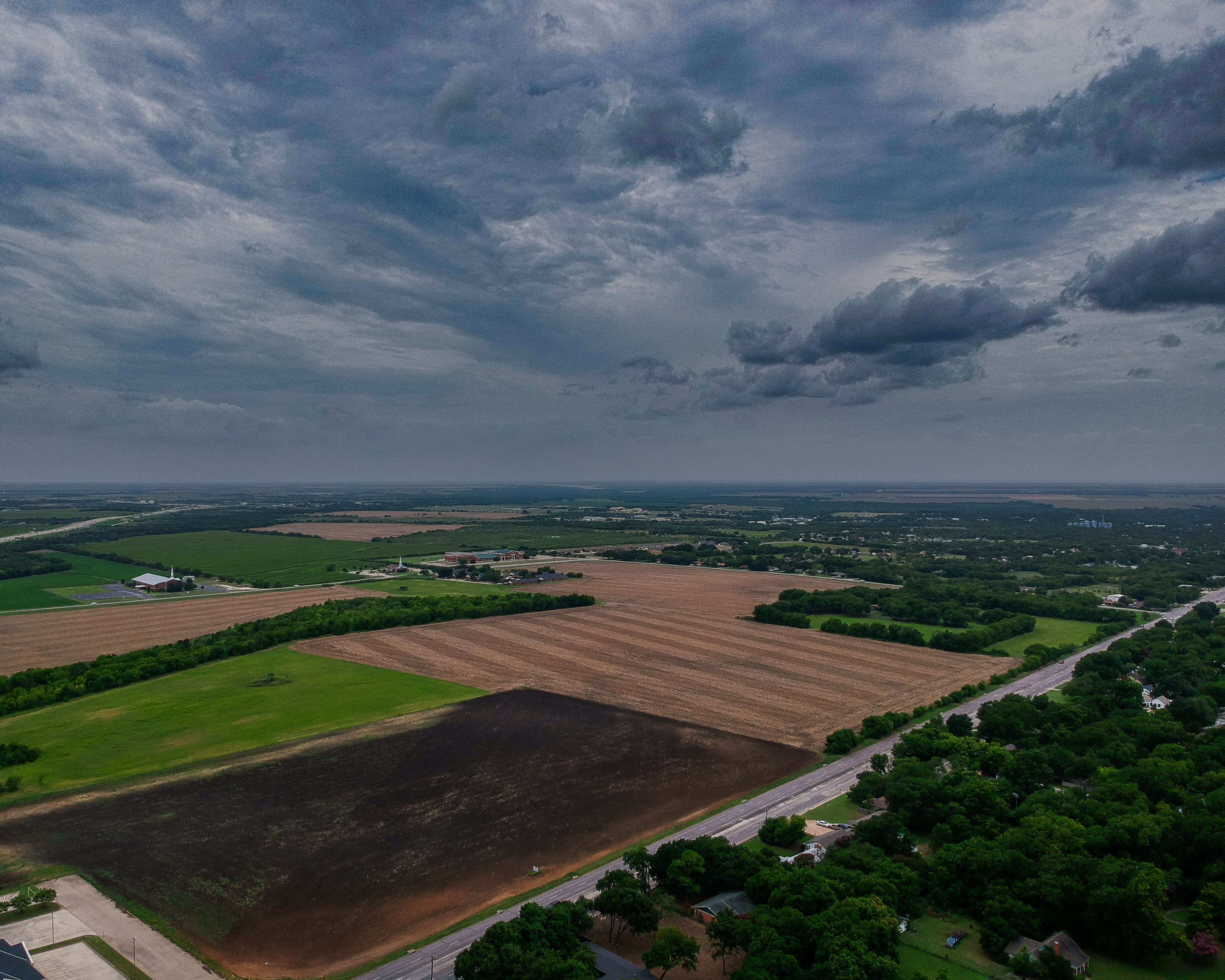 Moody Cloudy Sky over small town Hillsboro Texas Farm Fields
