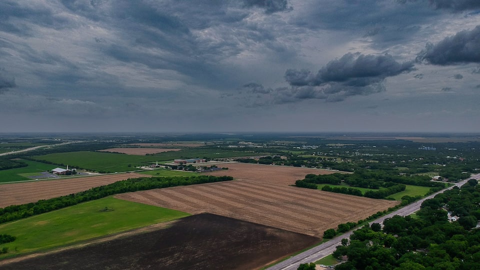 Moody Cloudy Sky over small town Hillsboro Texas Farm Fields