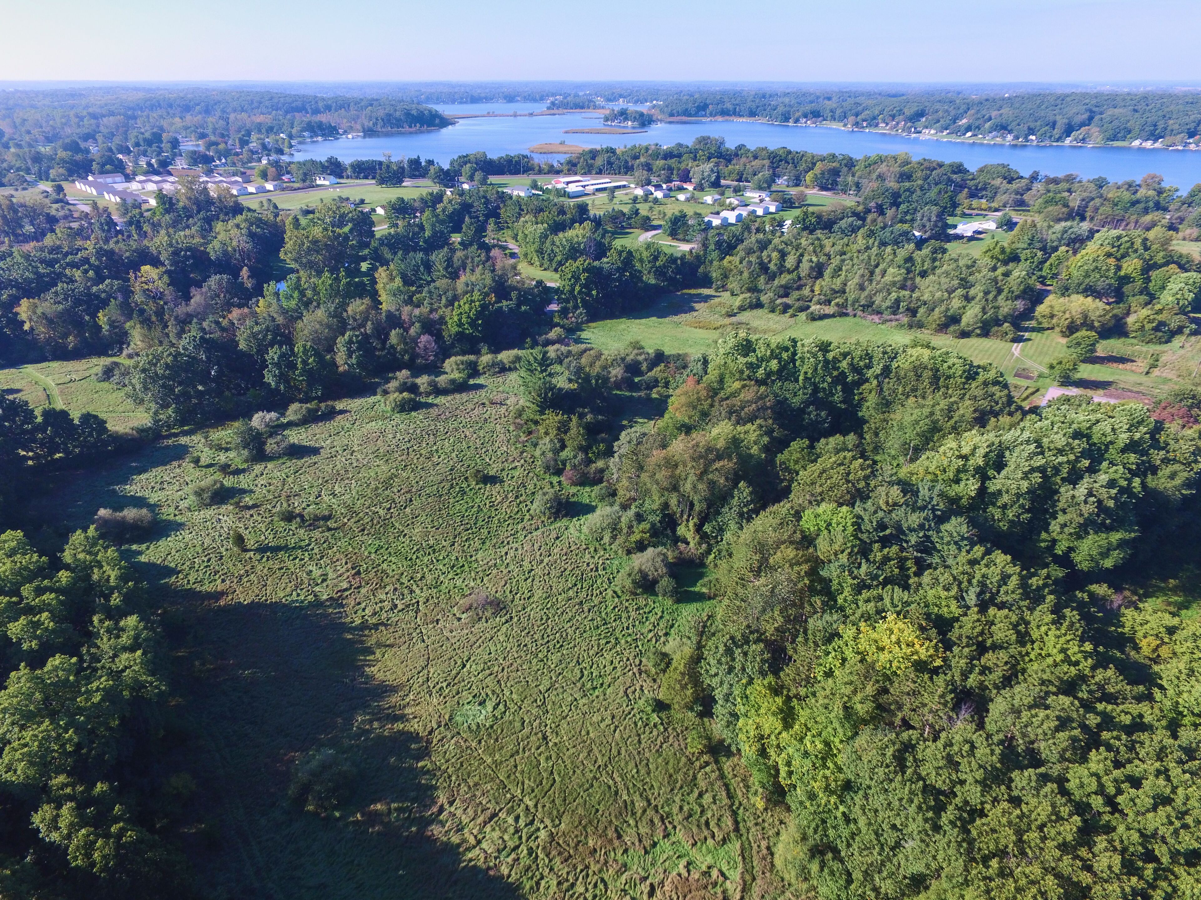 Aerial View of Serene Lakeside Community and Autumn Foliage