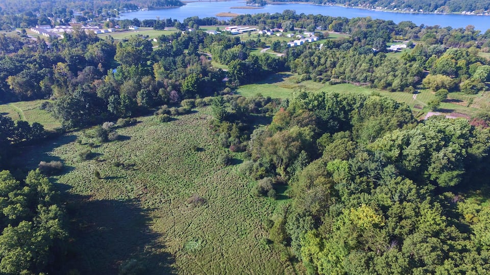 Aerial View of Serene Lakeside Community and Autumn Foliage