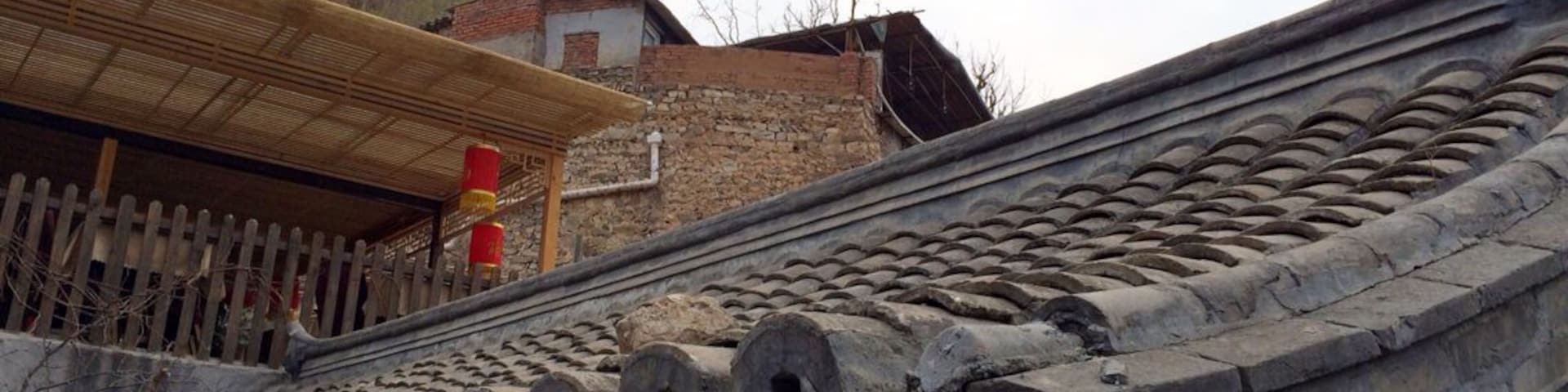 A traditional Chinese roof with a red flag.