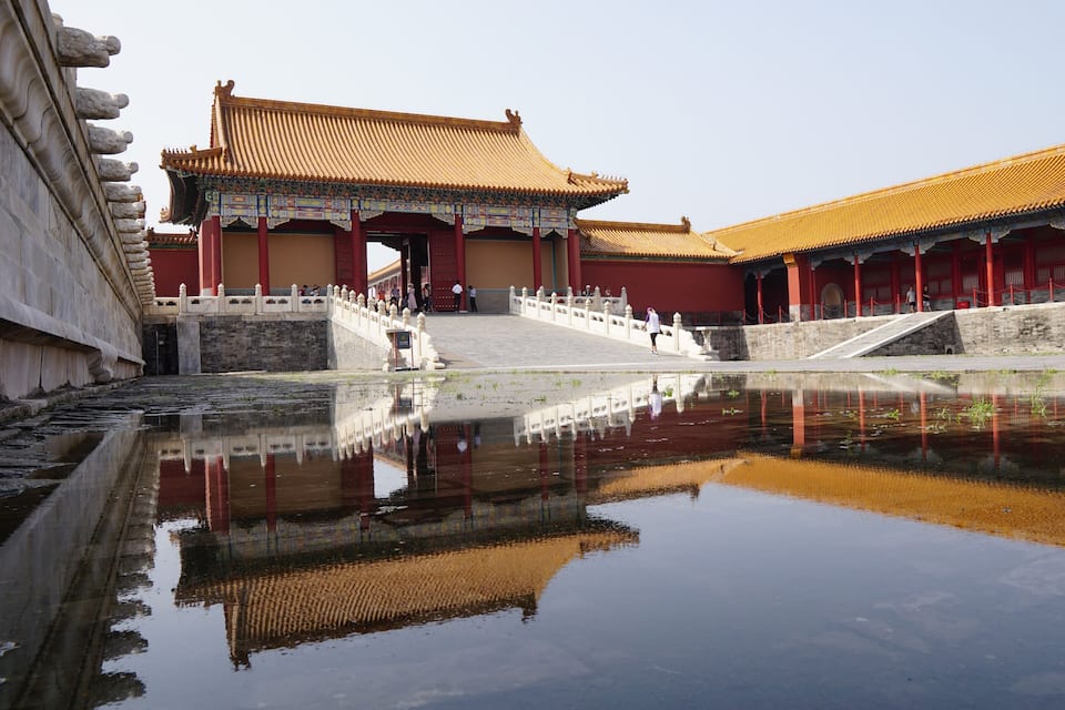 A traditional Chinese building with a reflection in the water.