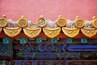 A traditional roof with ornate golden dragon decorations and colorful stained glass windows.