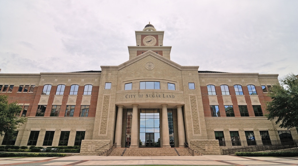 A large brick building with a clock tower and the inscription 'City of Sugar Land.'
