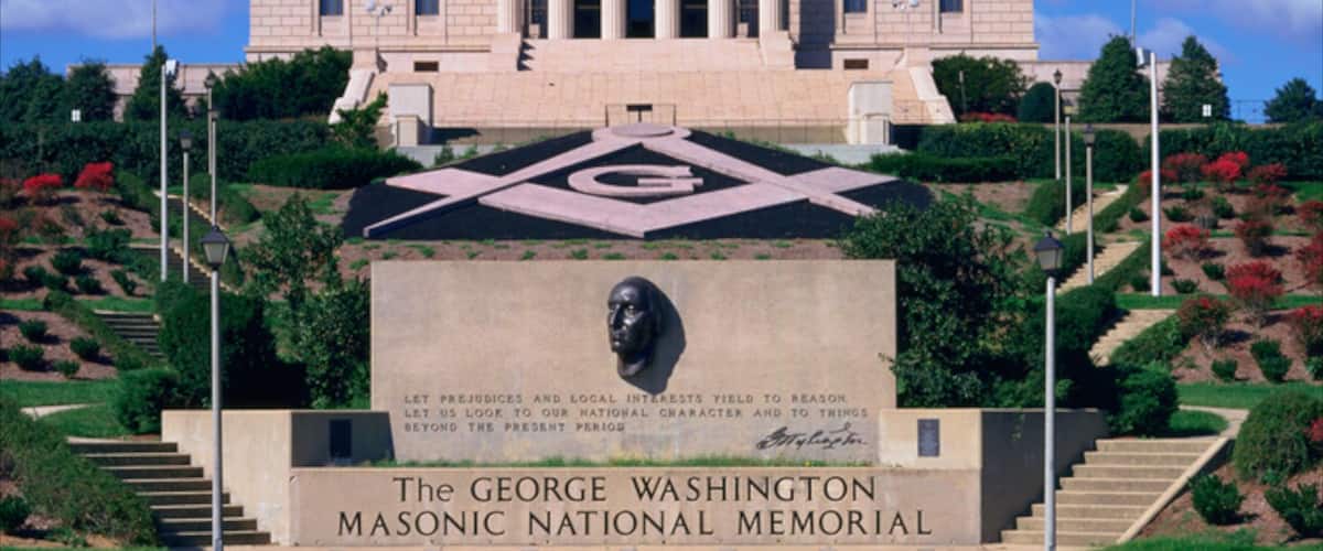 The George Washington Masonic National Memorial with a large Masonic symbol, a statue, and a grand building with columns.