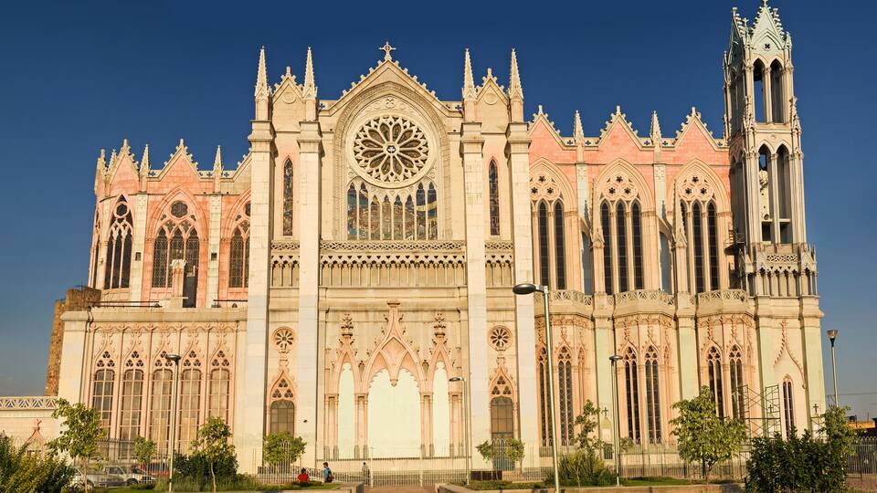 A large, ornate cathedral with intricate Gothic architecture, including pointed arches and a large rose window.
