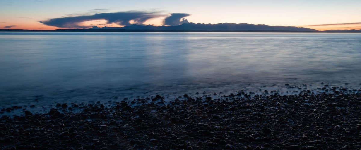 Evening Olympic National park mountain silhouette, sea and clouds in Picnic Point area, WA, USA