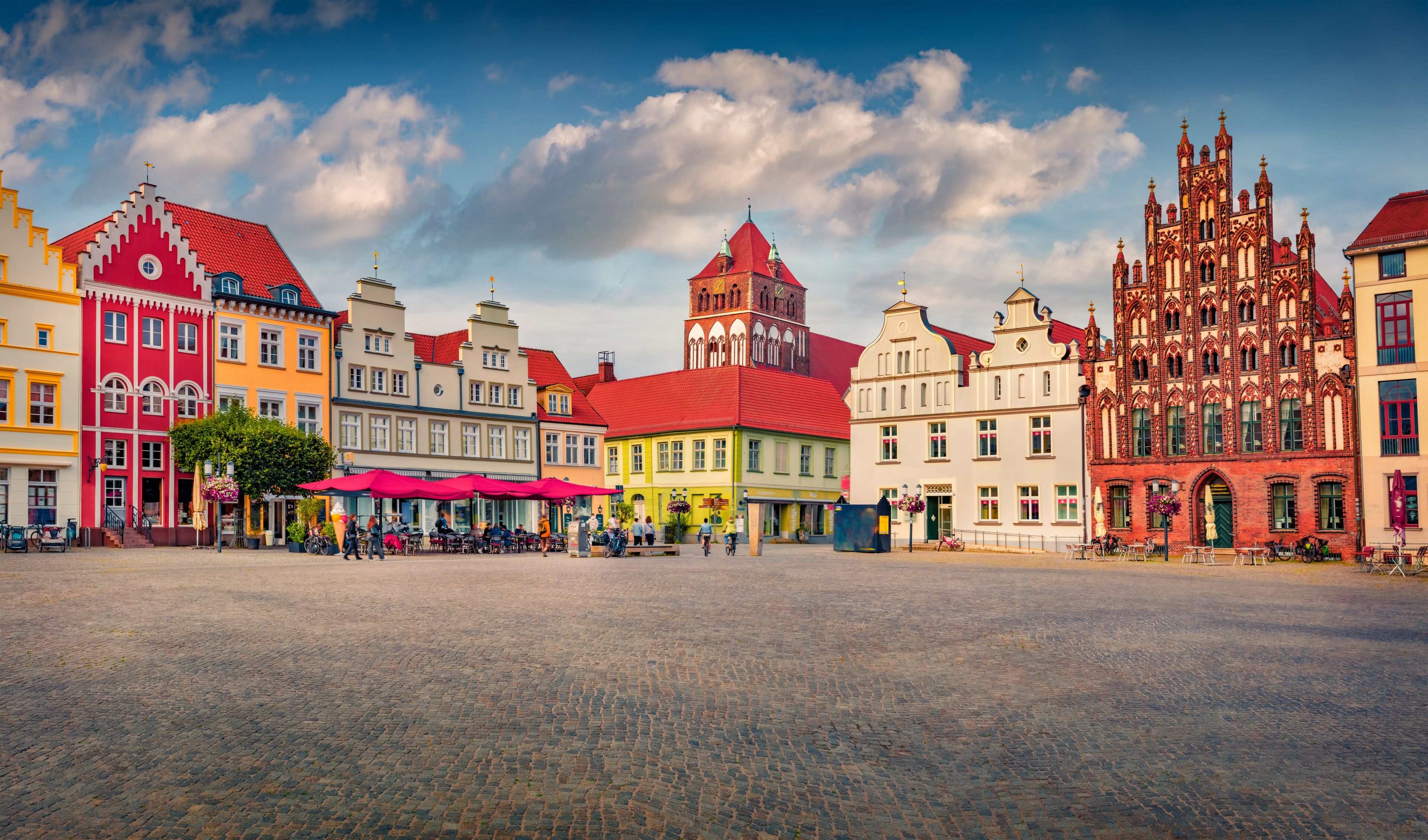 Splendid summer view of colorful building on Marktplatz. Amazing cityscape of Greifswald town with tower of Marienkirche church on background, Germany, Europe. Traveling concept background..